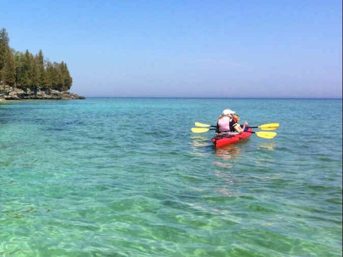 Paddlers enjoy a serene paddle on Lake Michigan
